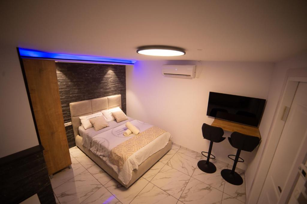 a bedroom with a bed and a flat screen tv at Orel suite in Eilat