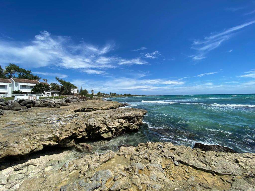 a view of the ocean from a rocky beach at OceanBlue Resort in Christ Church