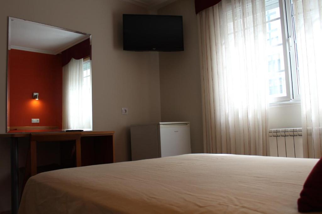 A bed or beds in a room at Hotel Rego Foz
