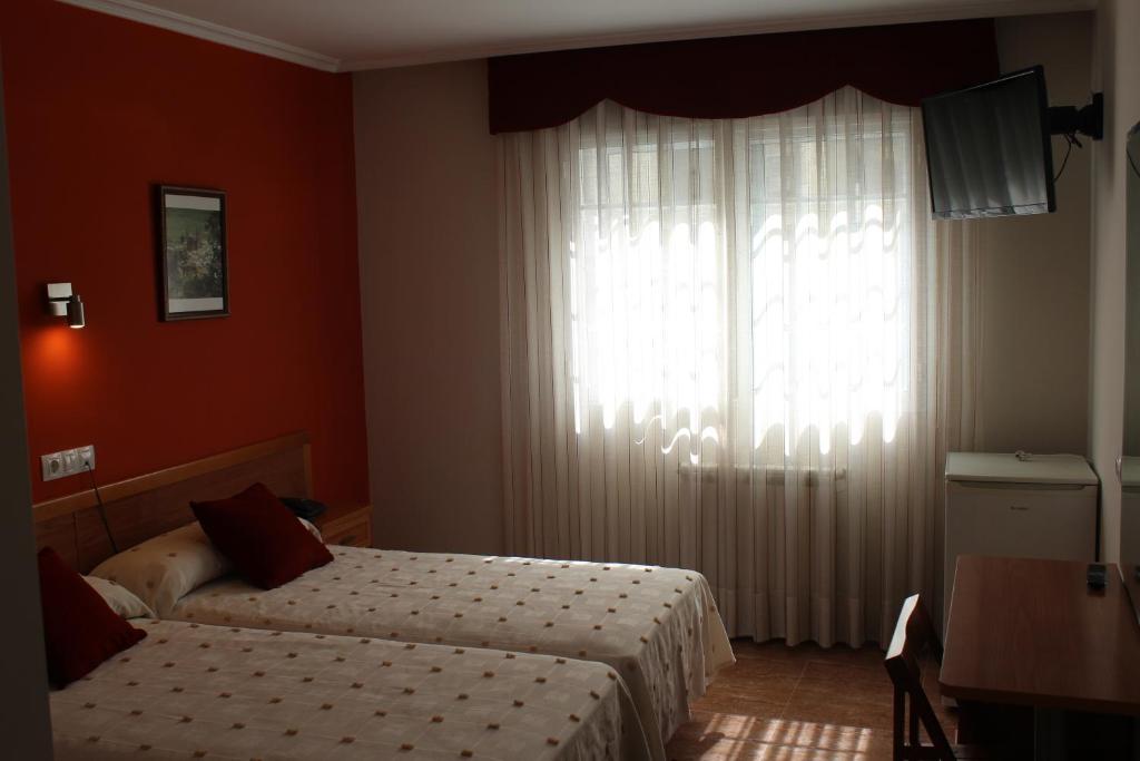 A bed or beds in a room at Hotel Rego Foz