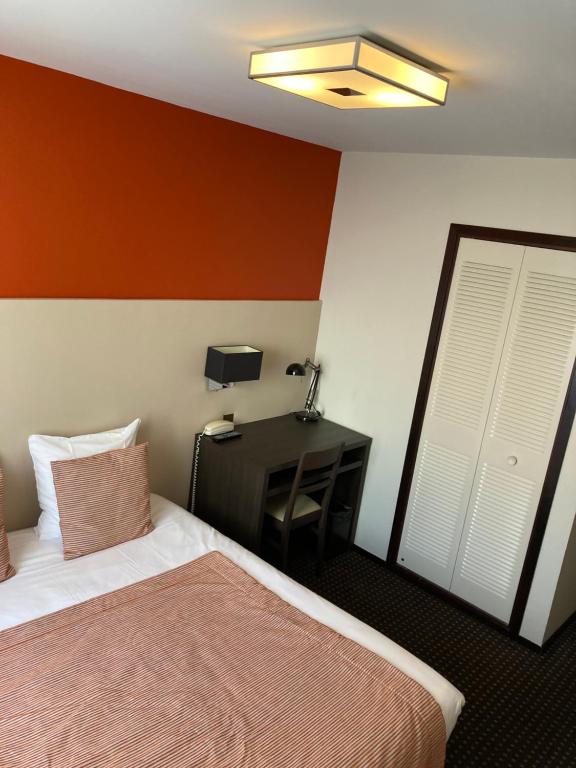 Postel nebo postele na pokoji v ubytování Hotel Georges