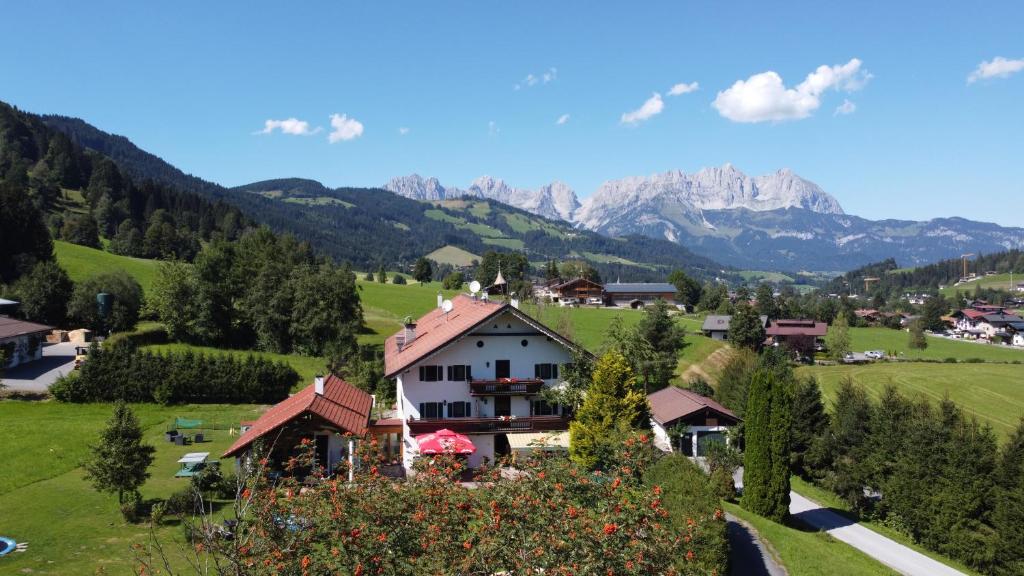 a village in a valley with mountains in the background at Pension Thainerhof in Reith bei Kitzbühel