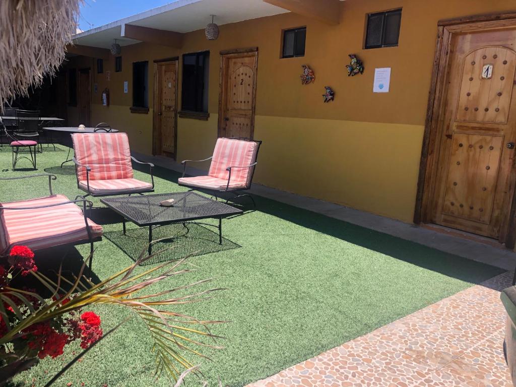 a patio with chairs and a table and a building at Hotel Isabela in San Carlos