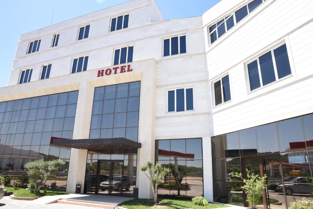 an office building with a hotel sign on it at Fjortes Palace in Vlorë