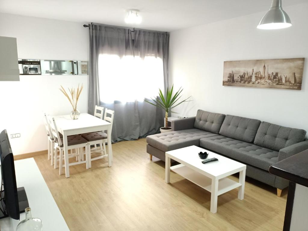 sala de estar con sofá y mesa en Apartamentos Coralba - El Escondite de la Bahía, en San Fernando