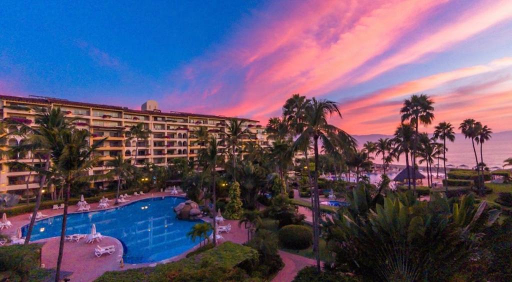 a view of a resort with a pool and palm trees at Velas Vallarta Condo in Puerto Vallarta