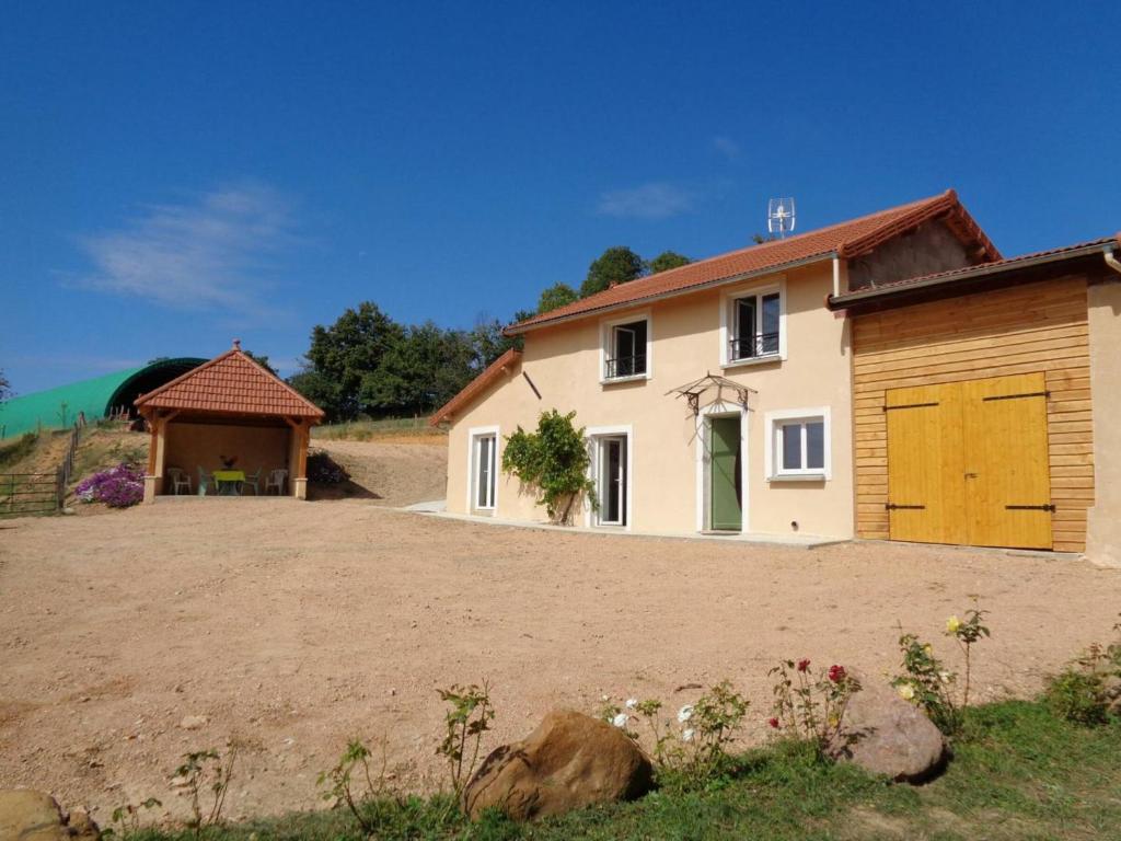 a house with a yellow garage and a building at Gîte Régny, 4 pièces, 6 personnes - FR-1-496-221 in Regny