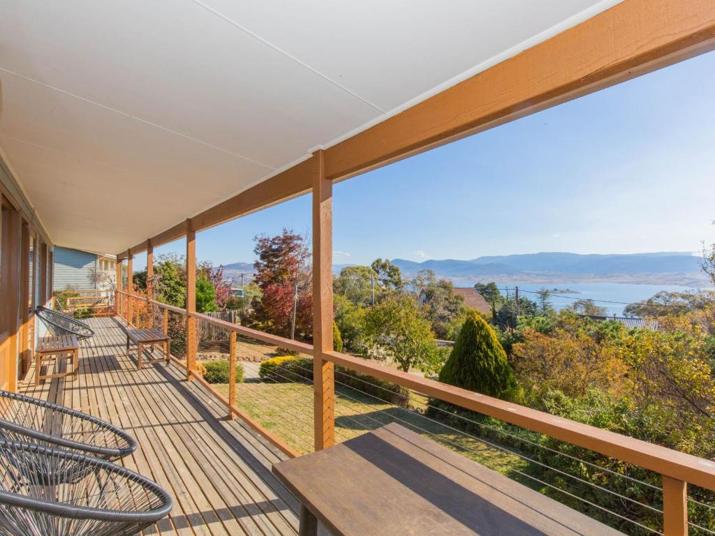 a balcony with chairs and a view of the water at Winterwood 9 Camira Ave in Jindabyne