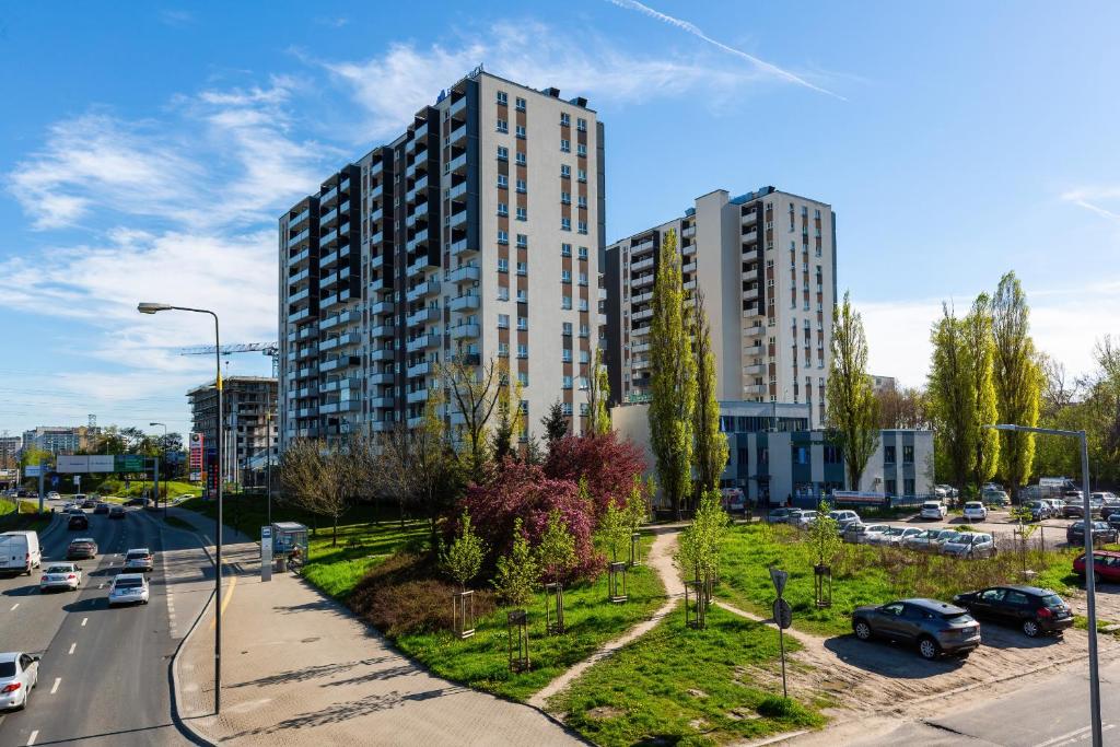 a city with tall buildings and a street with cars at Apartments Parks of Warsaw by Renters in Warsaw