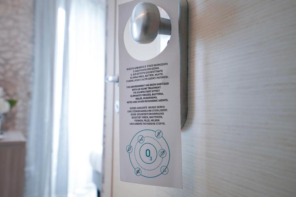 a sign on the door of a room at Sole Mare in Ventimiglia