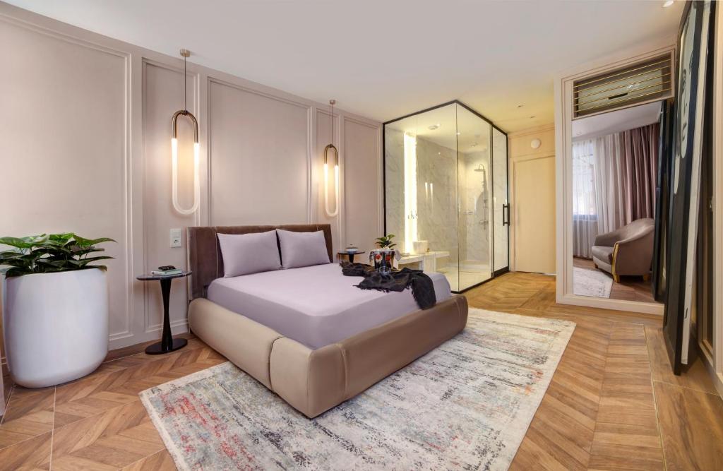 a bedroom with a large bed and a mirror at Walton Gardens Pera in Istanbul