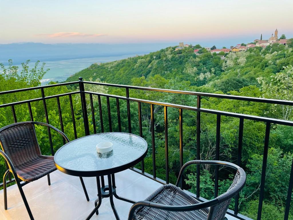 a table and chairs on a balcony with a view at Villa Royal in Sighnaghi