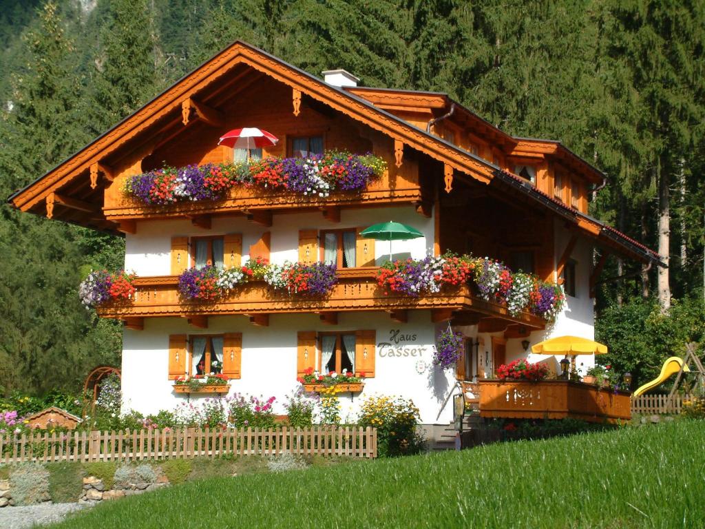a house with lots of flowers in front of it at Haus Tasser in Mayrhofen