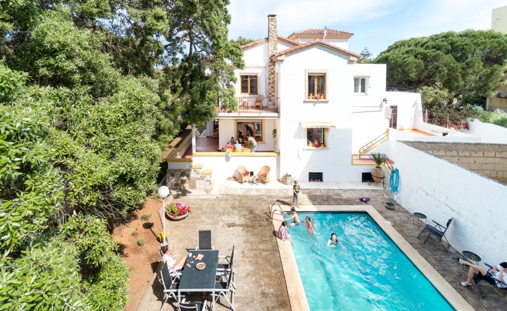 an aerial view of a house and a swimming pool at Casa Sa Posidonia -POSIDONIA SURF & STAY- in Ciutadella