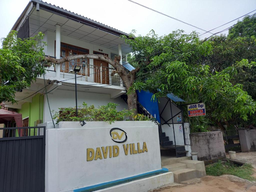 a sign in front of a building at David Villa in Anuradhapura