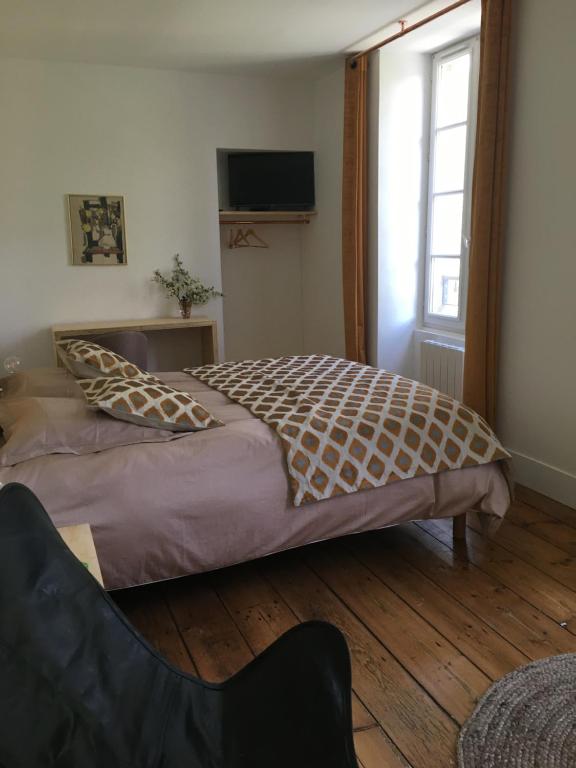 Postel nebo postele na pokoji v ubytování Chambres d hôtes du Moulin à papier