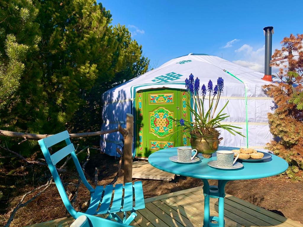 a table and a chair and a yurt at Valhalla Yurts Odin in Selfoss