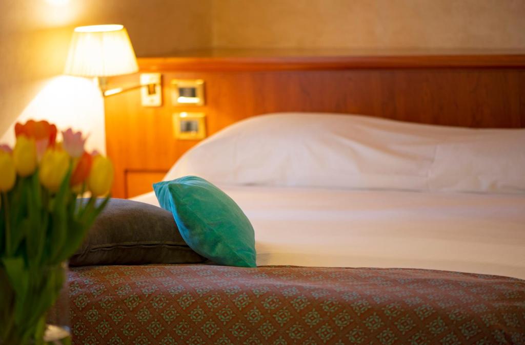 Łóżko lub łóżka w pokoju w obiekcie Hotel Corte Regina