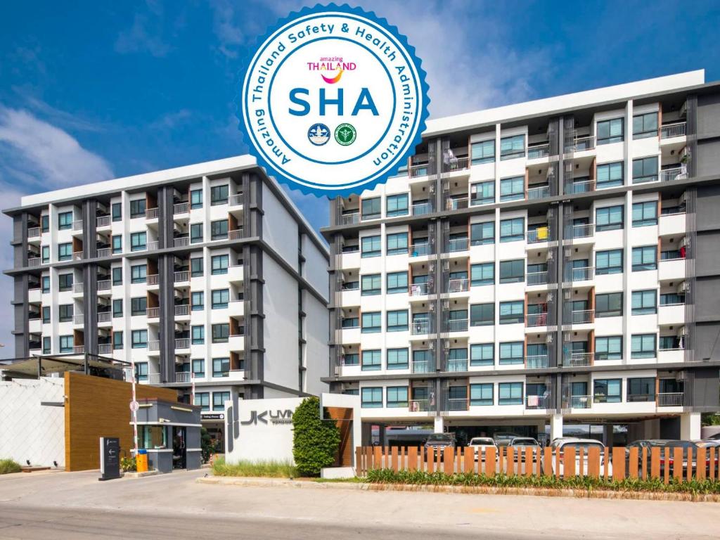 a building with a sha sign in front of it at JK LIVING Hotel And Service Apartment in Chachoengsao