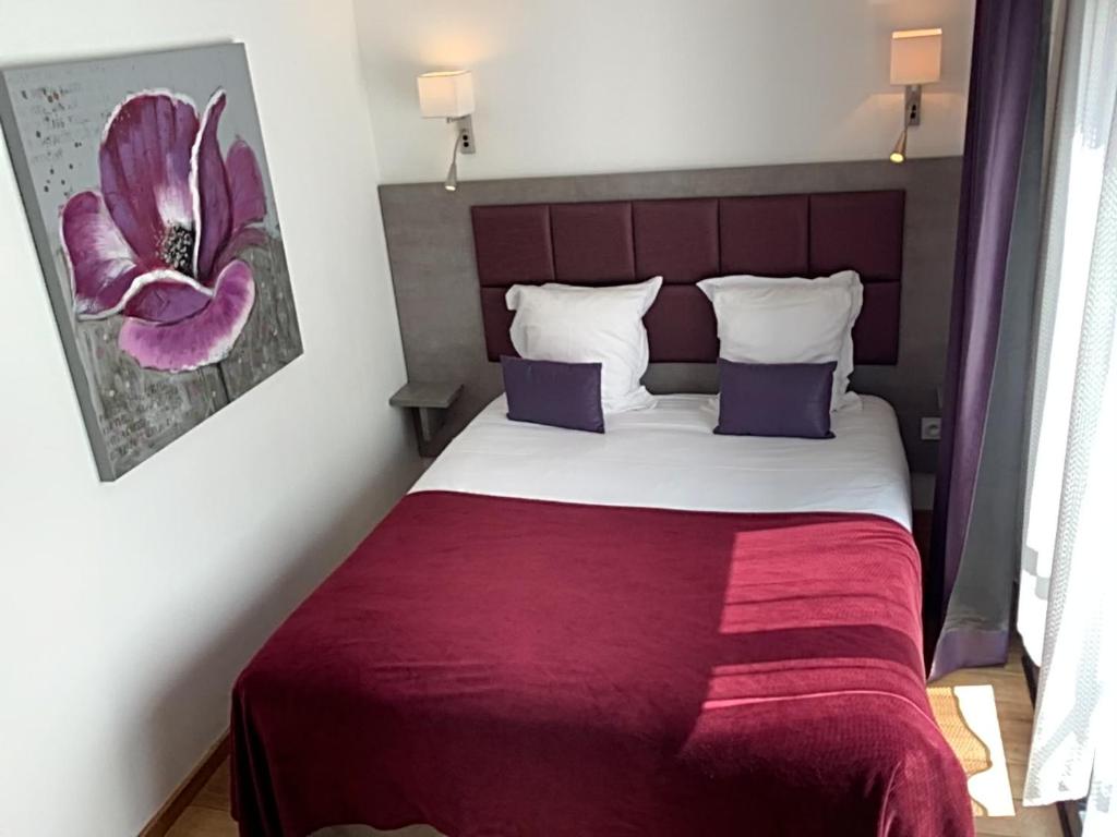 Postel nebo postele na pokoji v ubytování Hôtel Monet