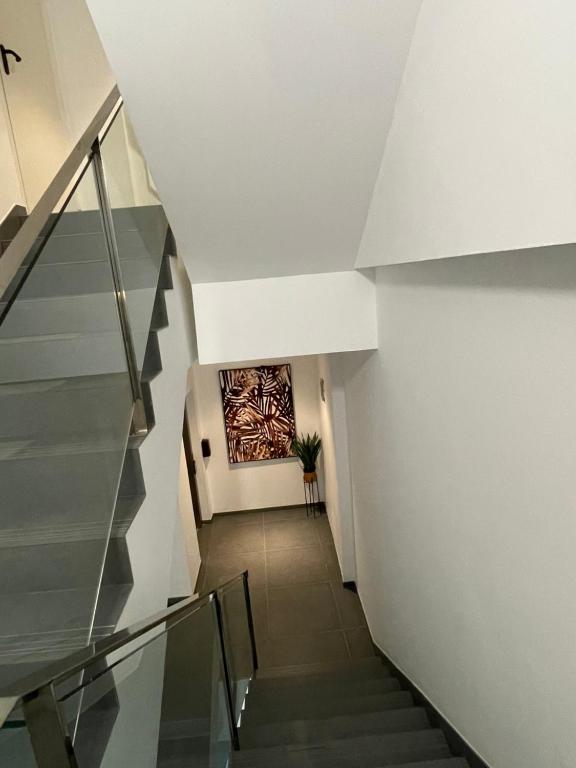 a hallway with stairs and a painting on the wall at Royal Flats in Las Palmas de Gran Canaria