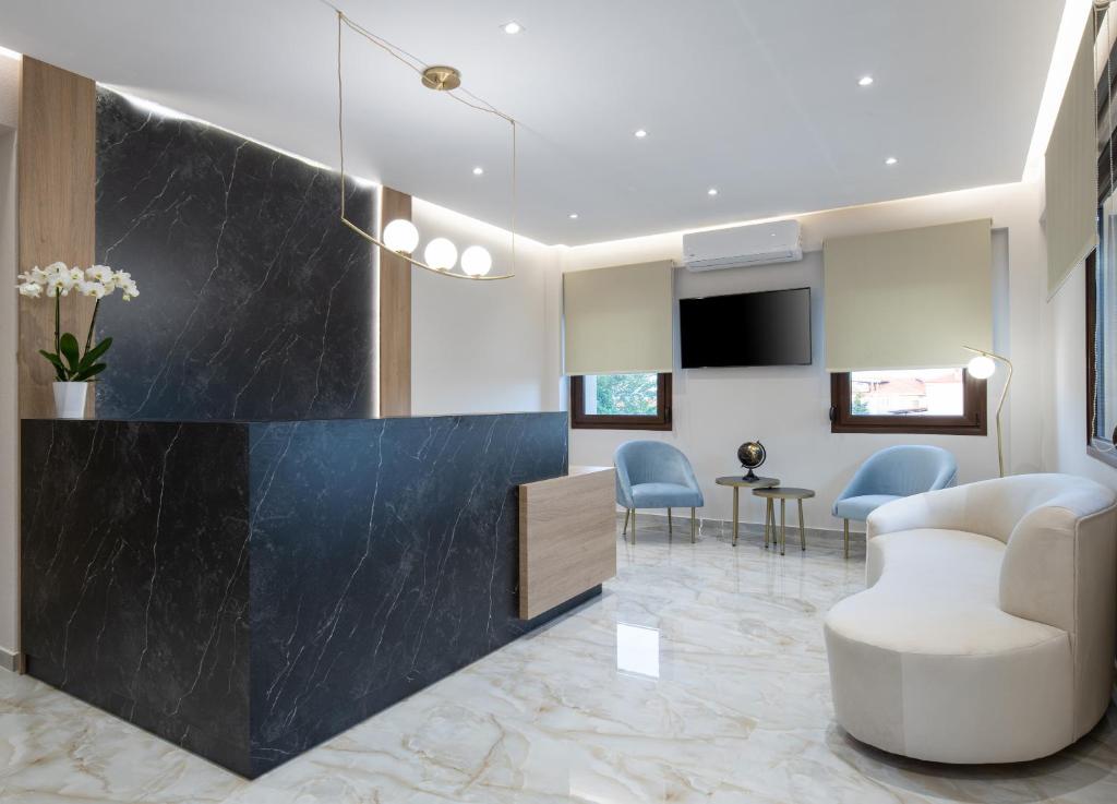 a lobby with a waiting room with a table and chairs at VagAthan - Lux Holidays in Afitos