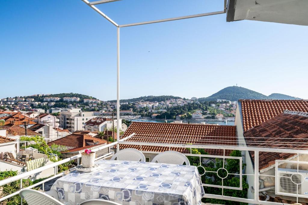 a table and chairs on a balcony with a view at Apartment & Rooms Alan in Dubrovnik