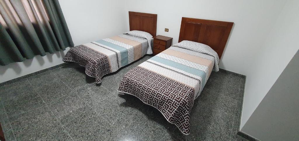 two beds sitting in a room with at LA MARINA III ÁTICO B in La Restinga