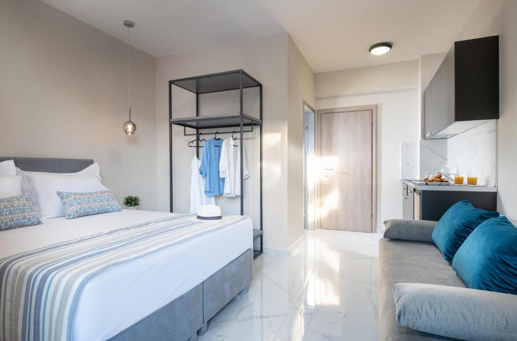a bedroom with a large bed and a couch at VagAthan - Lux Holidays in Afitos