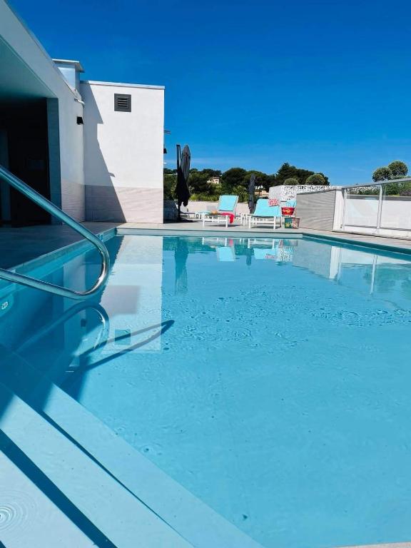 a swimming pool with blue water on top of a building at Lagrange Apart&#39;Hôtel Antibes Olympie in Antibes