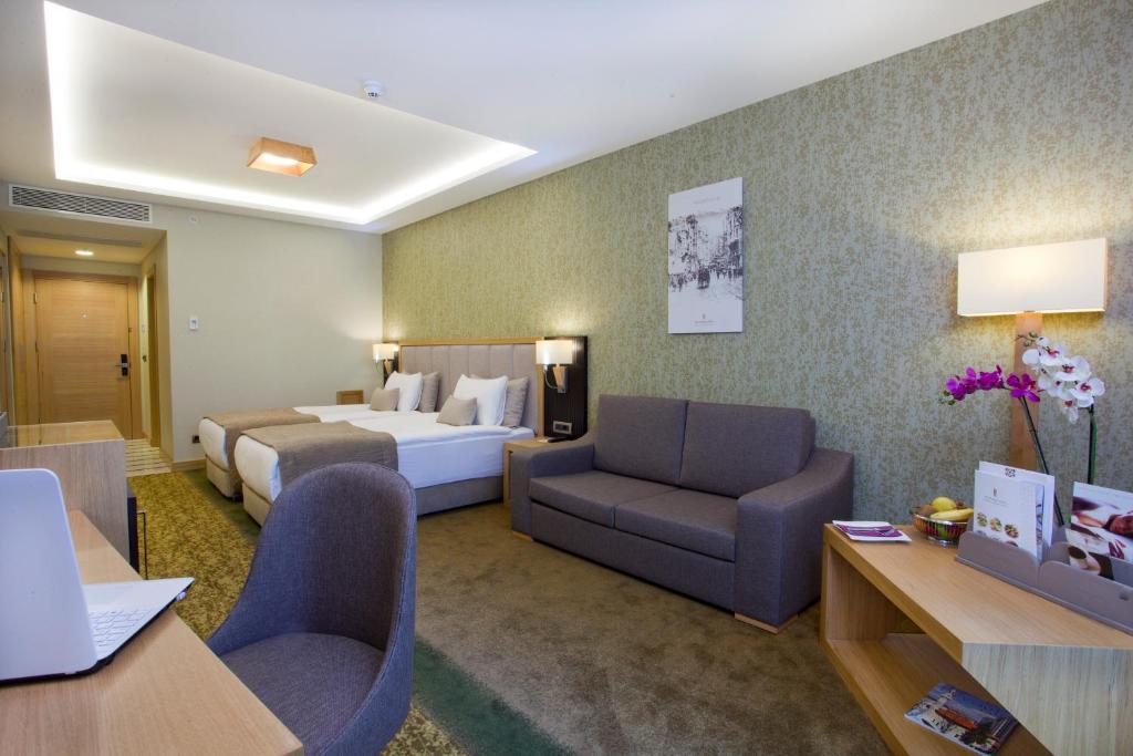 A bed or beds in a room at The Parma Hotel & Spa Taksim