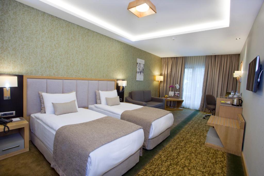 A bed or beds in a room at The Parma Hotel & Spa Taksim