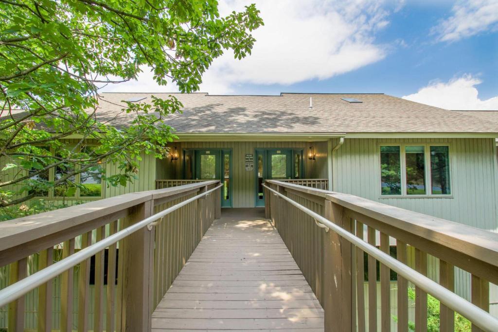 a boardwalk leading to a home with a house at The Summit at Massanutten Resort by TripForth in McGaheysville