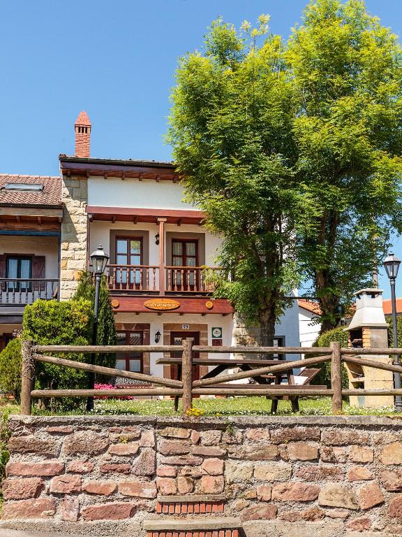 a wooden fence in front of a house at Casa Rosaura in Naveda