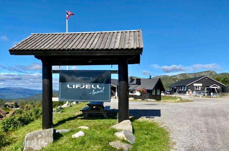 a sign sitting on the side of a road at Lifjelltunet in Lifjell