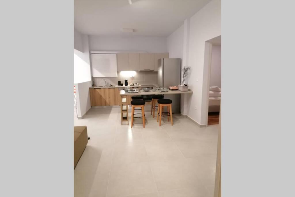 a kitchen and dining room with a table and chairs at Athens City Apartment next to Intercontinental I in Athens