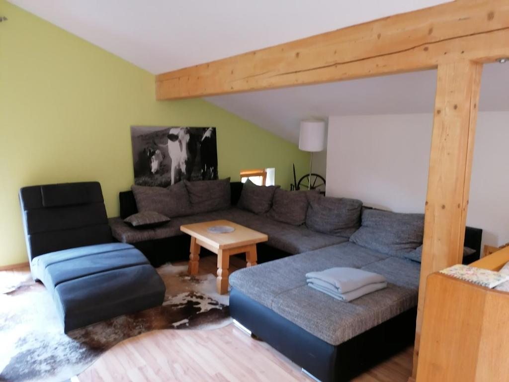 a living room with a couch and a table at Mosenbauer Ferienwohnung Salzburg in Mittersill