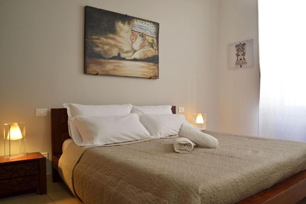 トラーパニにあるIl Moro e La Sicilianaのベッドルーム1室(壁に絵画が描かれたベッド1台付)