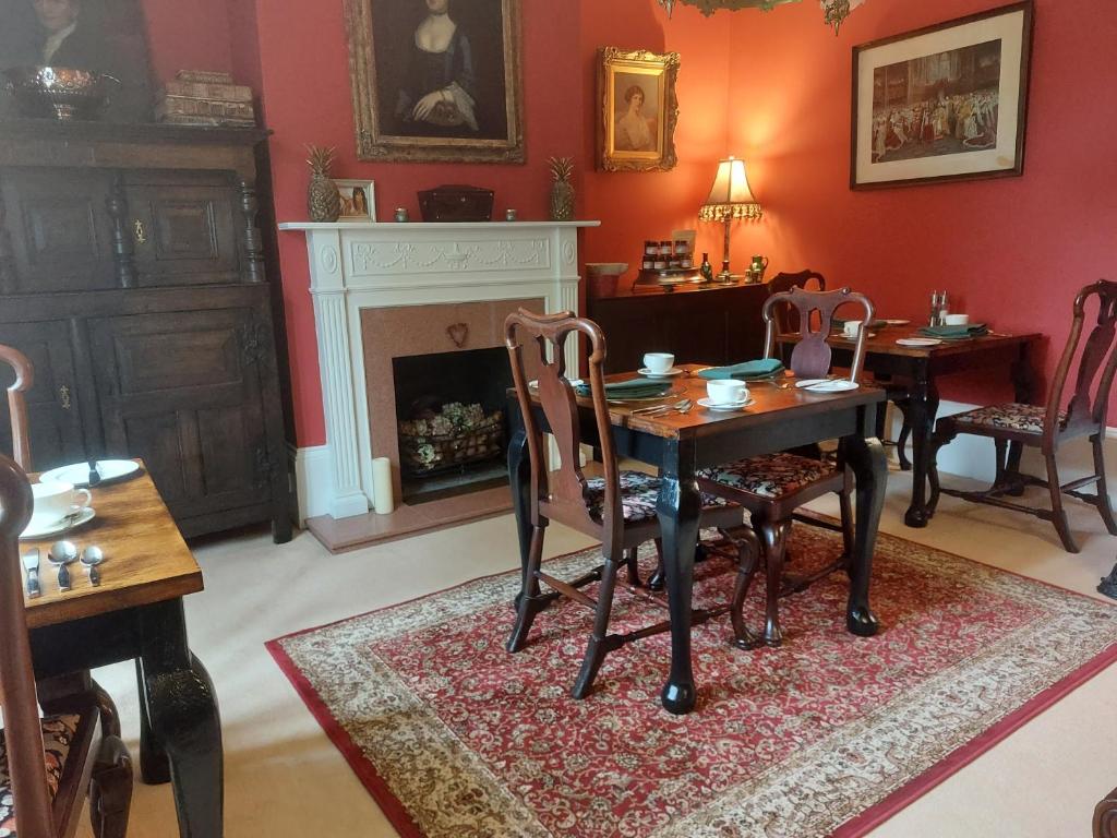 a living room filled with furniture and a fireplace at Blaisdon House B&B in Longhope