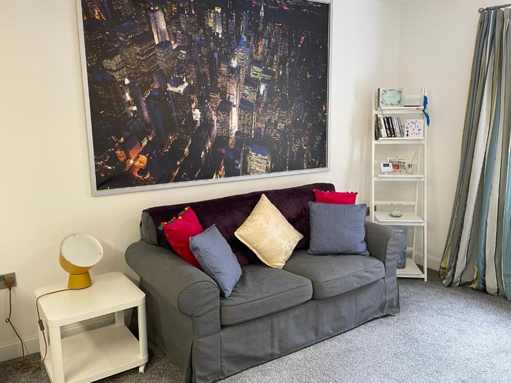 a living room with a couch with pillows on it at Fabulous One Bedroom Apartment in Ripon City Centre in Ripon