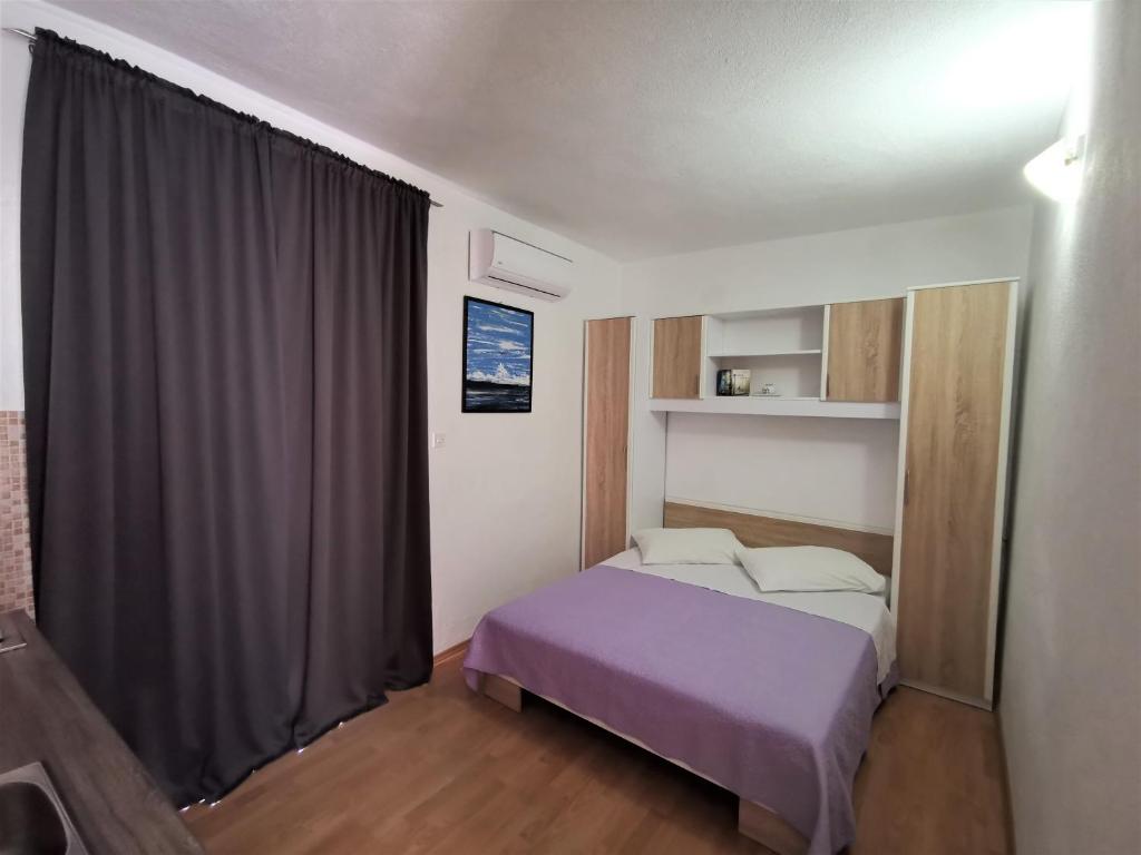Postel nebo postele na pokoji v ubytování Apartmani Divić