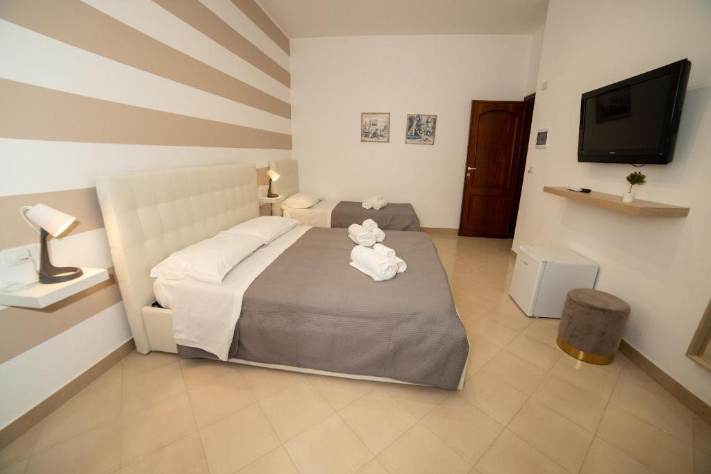 Postel nebo postele na pokoji v ubytování b&b Zio Luciano