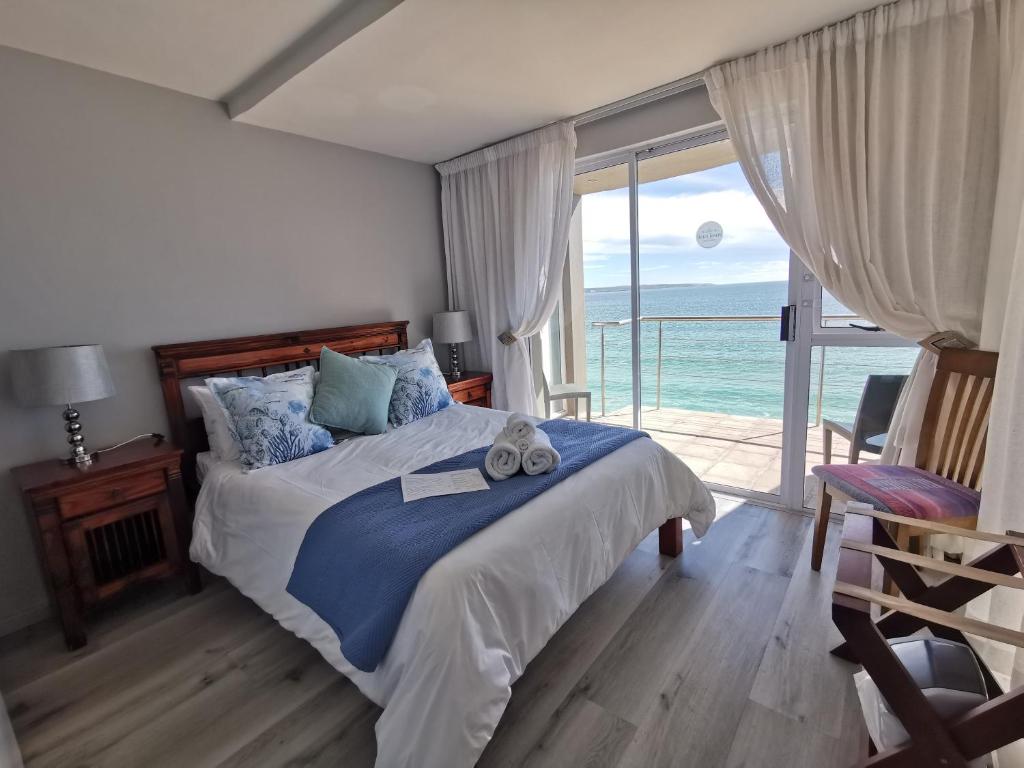 a bedroom with a bed with a cross on it at Langebaan Beach Towers in Langebaan