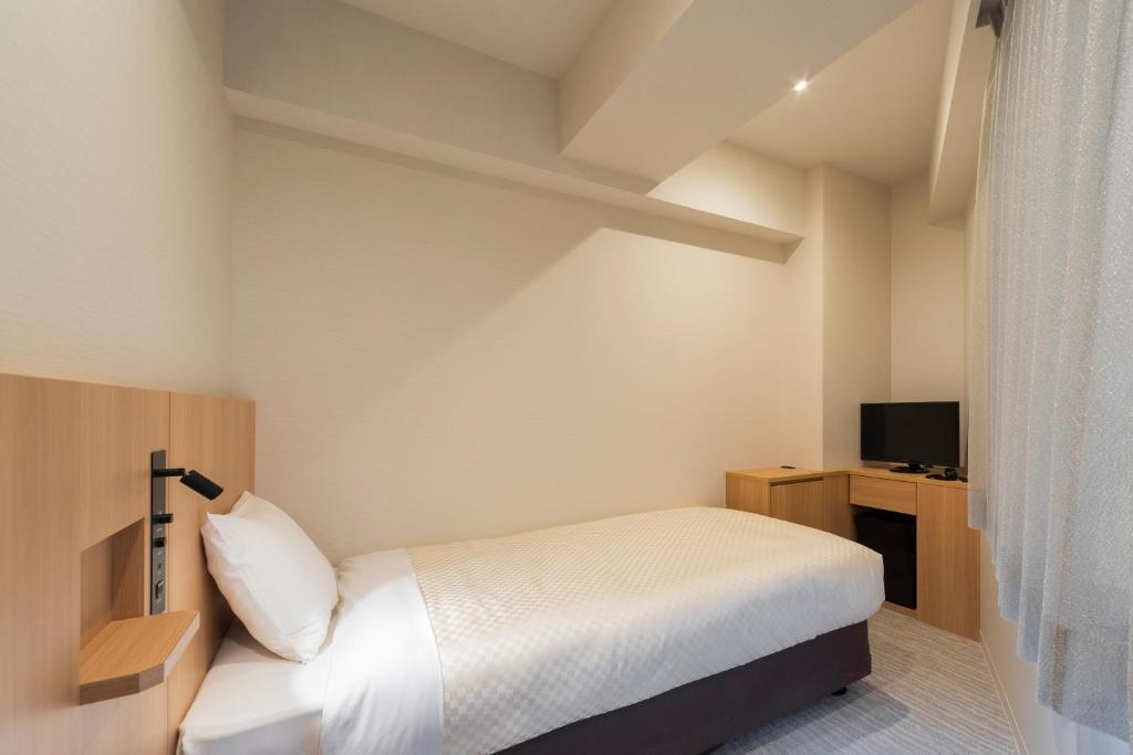 Postel nebo postele na pokoji v ubytování Nesthotel alt Kuramae Station
