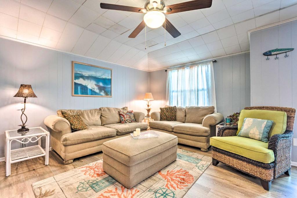 a living room with couches and a ceiling fan at Fort Walton Coastal Retreat with Yard Walk to Beach in Fort Walton Beach