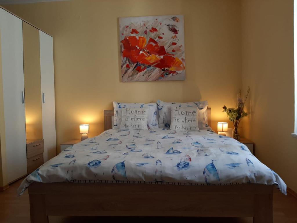 a bedroom with a bed with pillows and a painting at Zadar Old City Apartment Leonardo in Zadar
