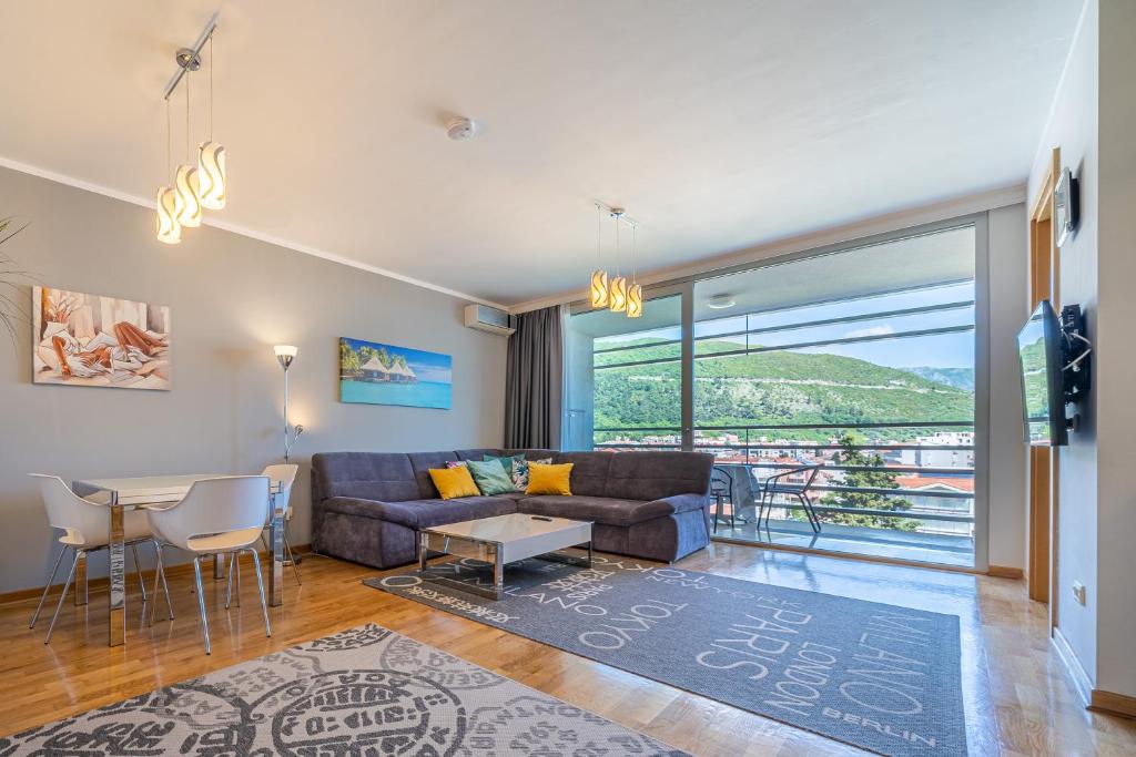 a living room with a couch and a table at Sea View Apartments in Budva in Budva