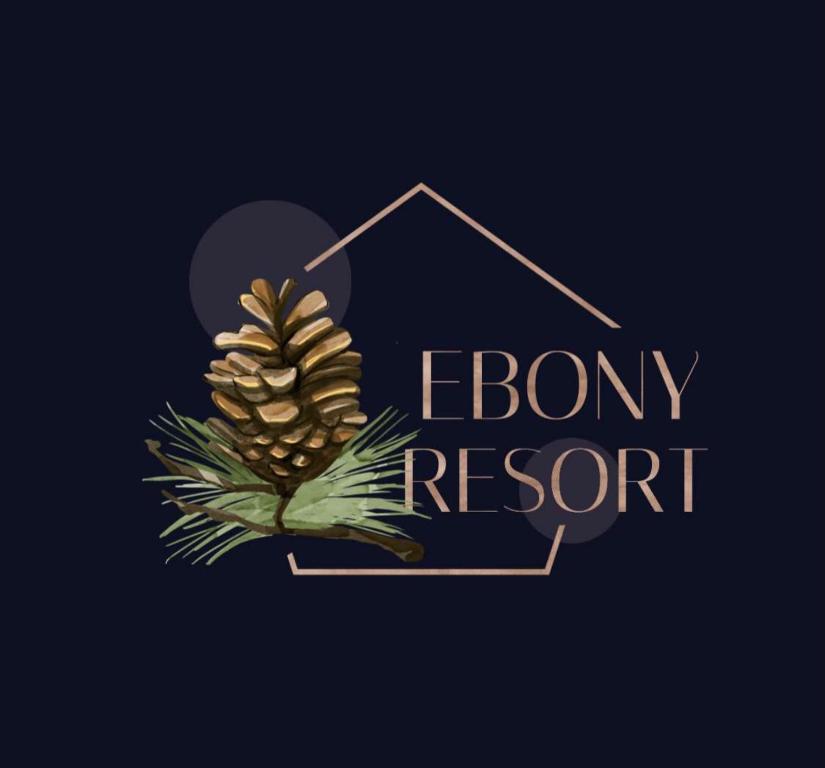 a pine cone with abow resort logo at الأيبنوس EBONyشالية فندقي بصالة سينما ومسبح بجهاز تدفئة in Khamis Mushayt