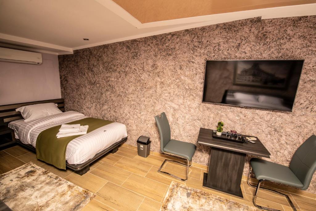 Postel nebo postele na pokoji v ubytování Hotel Novotheos