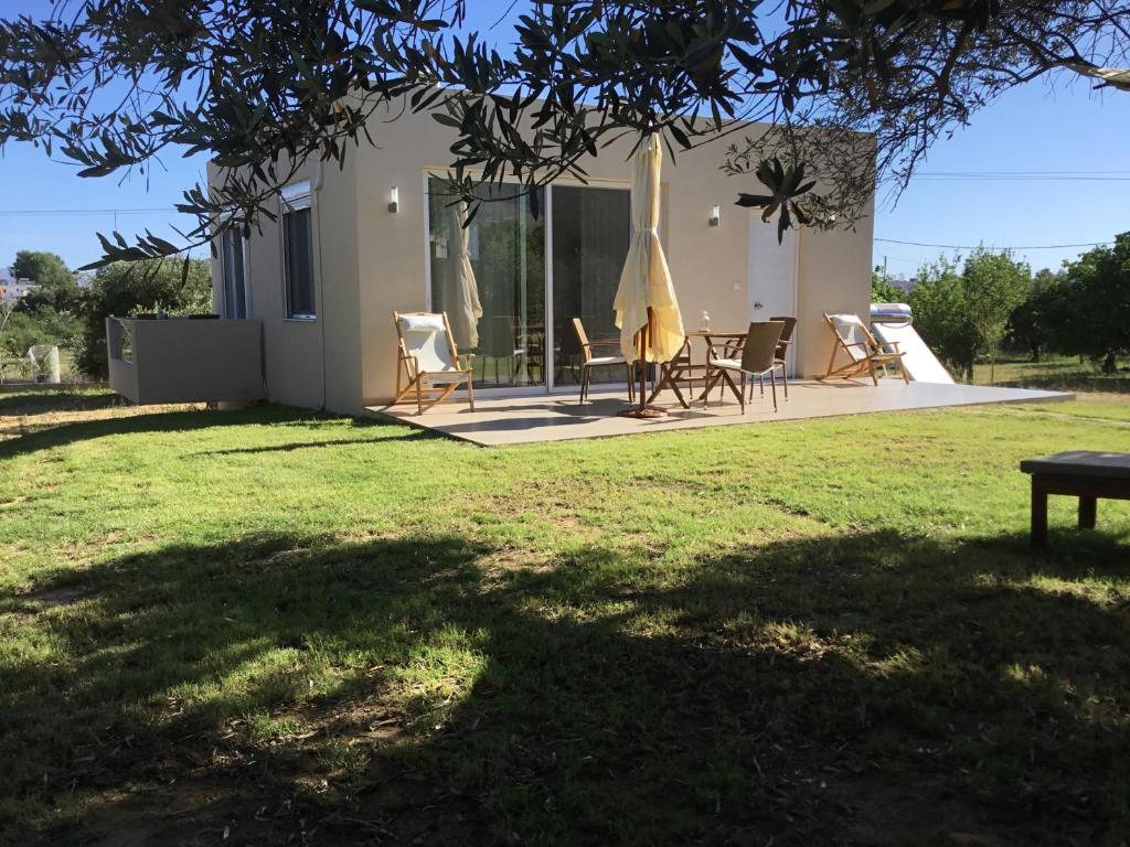 a group of chairs and umbrellas in a yard at Oikia Ampavris in Kos Town